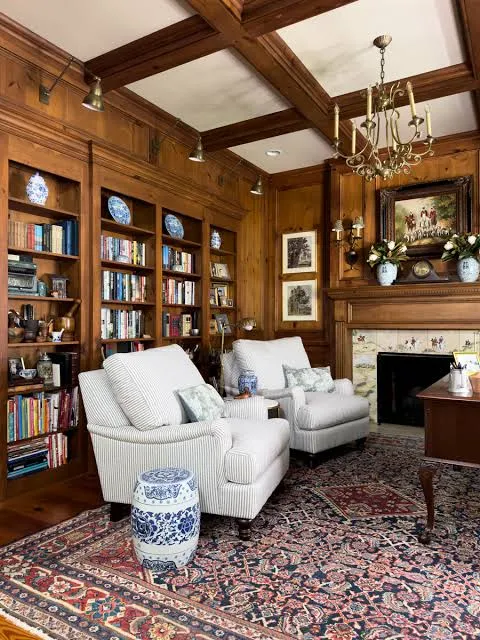 Traditional home library with warm wood and comfortable chairs