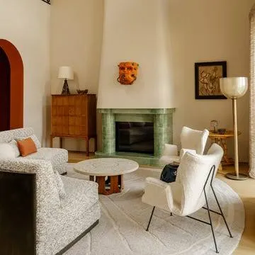 Rustic modern living room with stone fireplace and natural textures